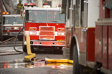 Firetrucks parked with hoses