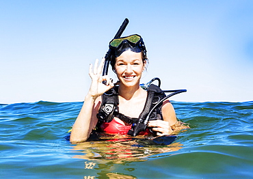 Portrait of young woman scuba-diving in sea, Jupiter, Florida