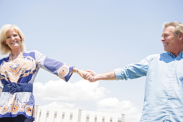 Portrait of smiling couple holding hands