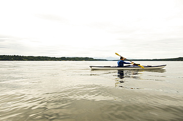 Man kayaking on lake, Olympia, Washington, USA