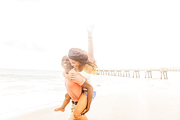 Young couple playing on beach, Jupiter, Florida