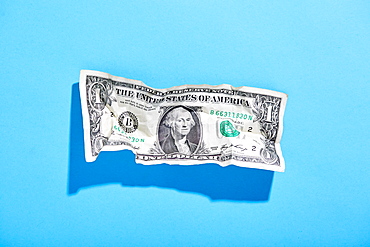 One dollar bill on blue background