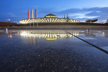 Poland, Holy Cross, Kielce, Bus station reflecting in puddle