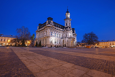 Poland, Lesser Poland, Nowy Sacz, Town hall at town square illuminated at dusk