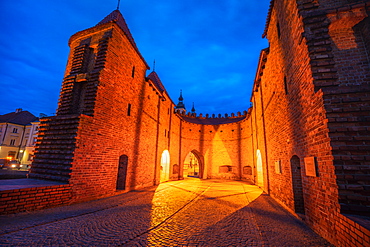 Poland, Masovia, Warsaw, Old City walls and barbican illuminated at night