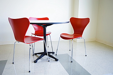 Empty table and red chair in cafeteria