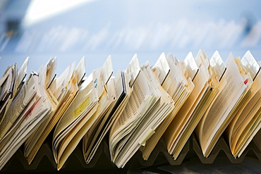 Close-up of files stacked on desk in office