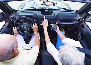 Senior couple in convertible car