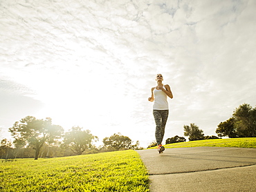 Woman running in park, Irvine, California