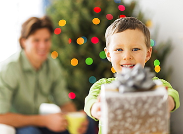 Boy (6-7) holding present