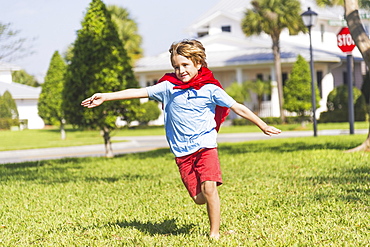 Boy (8-9) running with cape, Jupiter, Florida, USA