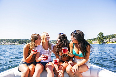 Young women having fun on motorboat, USA, Washington, Bellingham 