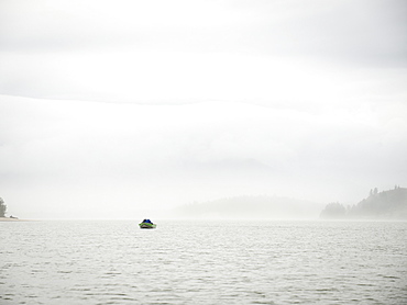 Distant view of people in boat, Rockaway Beach, Oregon