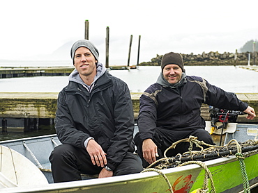 Portrait of men in boat, Rockaway Beach, Oregon