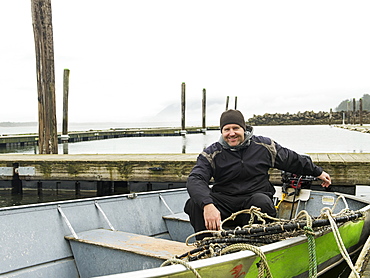 Portrait of man in boat, Rockaway Beach, Oregon