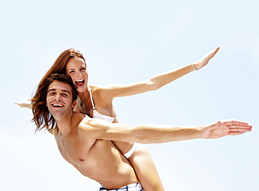 Young attractive couple enjoying summer holiday on beach