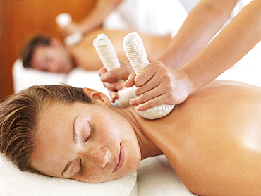 Two people getting massage in spa