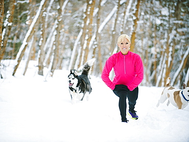 Woman exercising in winter forest, Salt Lake City, Utah USA