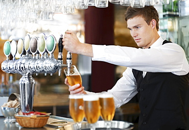 Bartender pouring beer