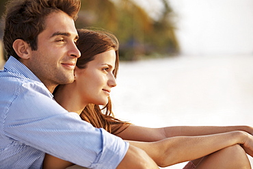 Portrait of couple hugging on beach