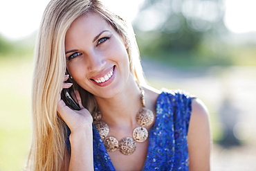 Portrait of smiling woman using mobile phone