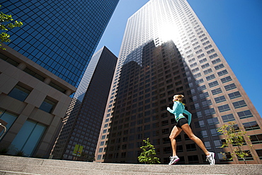 USA, California, Los Angeles, Young woman running in city, USA, California, Los Angeles
