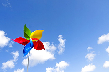 Colorful pinwheel blowing in wind against sky