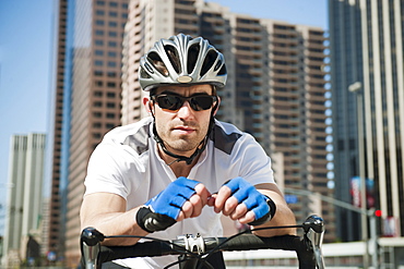 USA, California, Los Angeles, Portrait of young man road cycling on city street, USA, California, Los Angeles