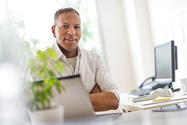 Portrait of smiling mature man working in home office