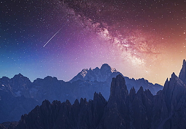 Italy, Veneto, Cortina d'Ampezzo, Dolomites, Milky way and falling star over rocky mountains