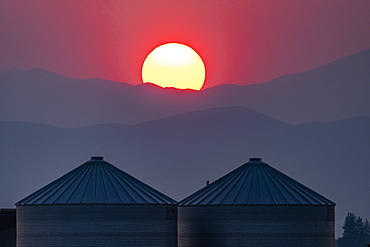 USA, Idaho, Bellevue, Storage silos at sunset