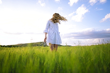 Young woman standing in agricultural field