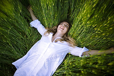 Young woman lying in grass