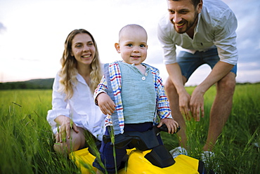 Parents with baby son (12-17 months) in agricultural field