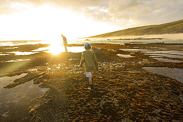 South Africa, Western Cape, Boy (8-9) and girl (16-17) exploring tidal pools in Lekkerwater Nature Reserve