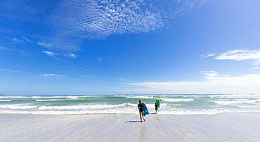 Girl (16-17) and boy (8-9) with body boards on Grotto Beach