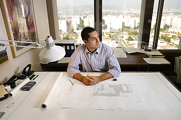 Architect sitting at draft table