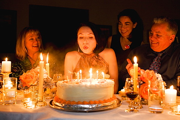 Group of friends celebrating birthday in restaurant