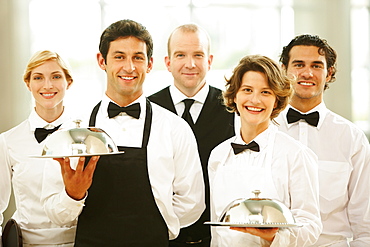 Group of waiters carrying trays