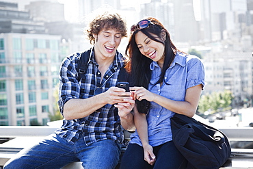 USA, Washington, Seattle, Couple looking at mobile phone