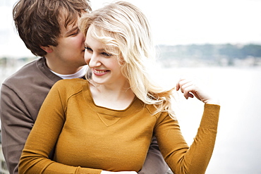 Young couple embracing on pier