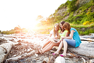 Three young women hanging out on beach