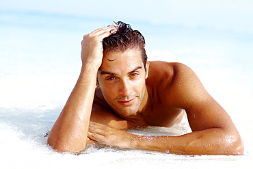 Portrait of attractive young man relaxing on beach