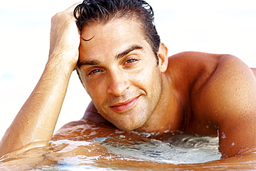 Portrait of attractive young man relaxing on beach