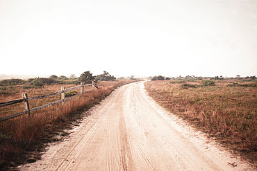Dirt road crossing grassy fields leading to Cisco Beach