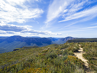 Soft clouds above mountain landscape on sunny day
