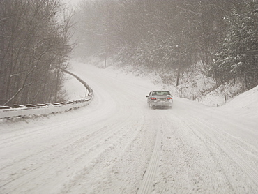 Car on country road in blizzard