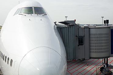 Commercial aeroplane with passenger boarding bridge