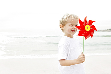 Boy (4-5) holding red pinwheel