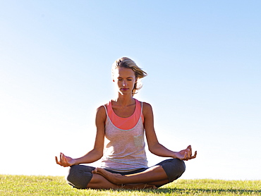 Woman meditating outside